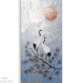 two white cranes with black and red accents perched on a branch, with a large red sun in the sky above them.