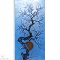 a branch with blue flowers against a blue background.